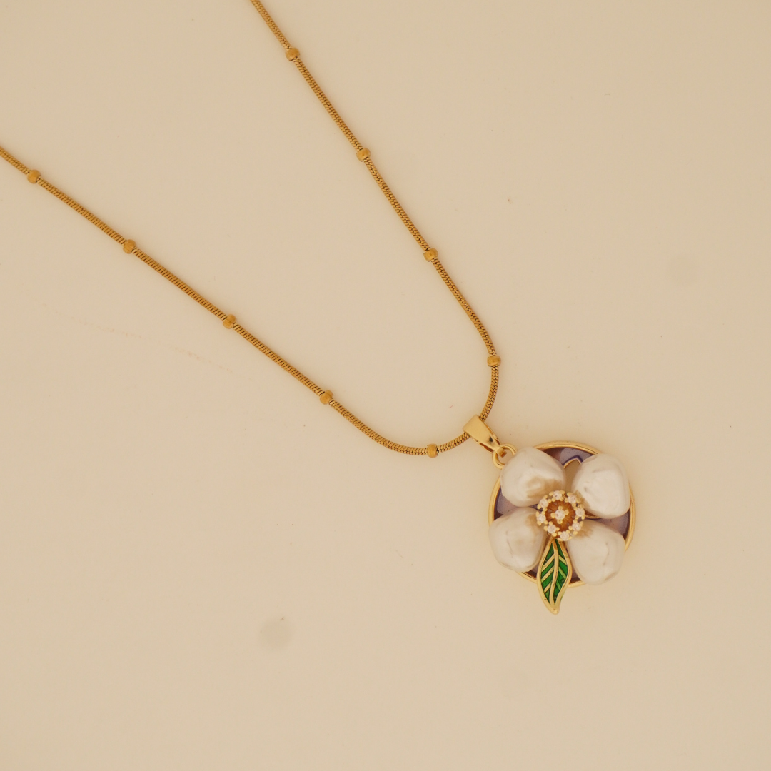 PetalMuse Pendant Necklace with white flower and green enamel leaf on beaded gold chain
